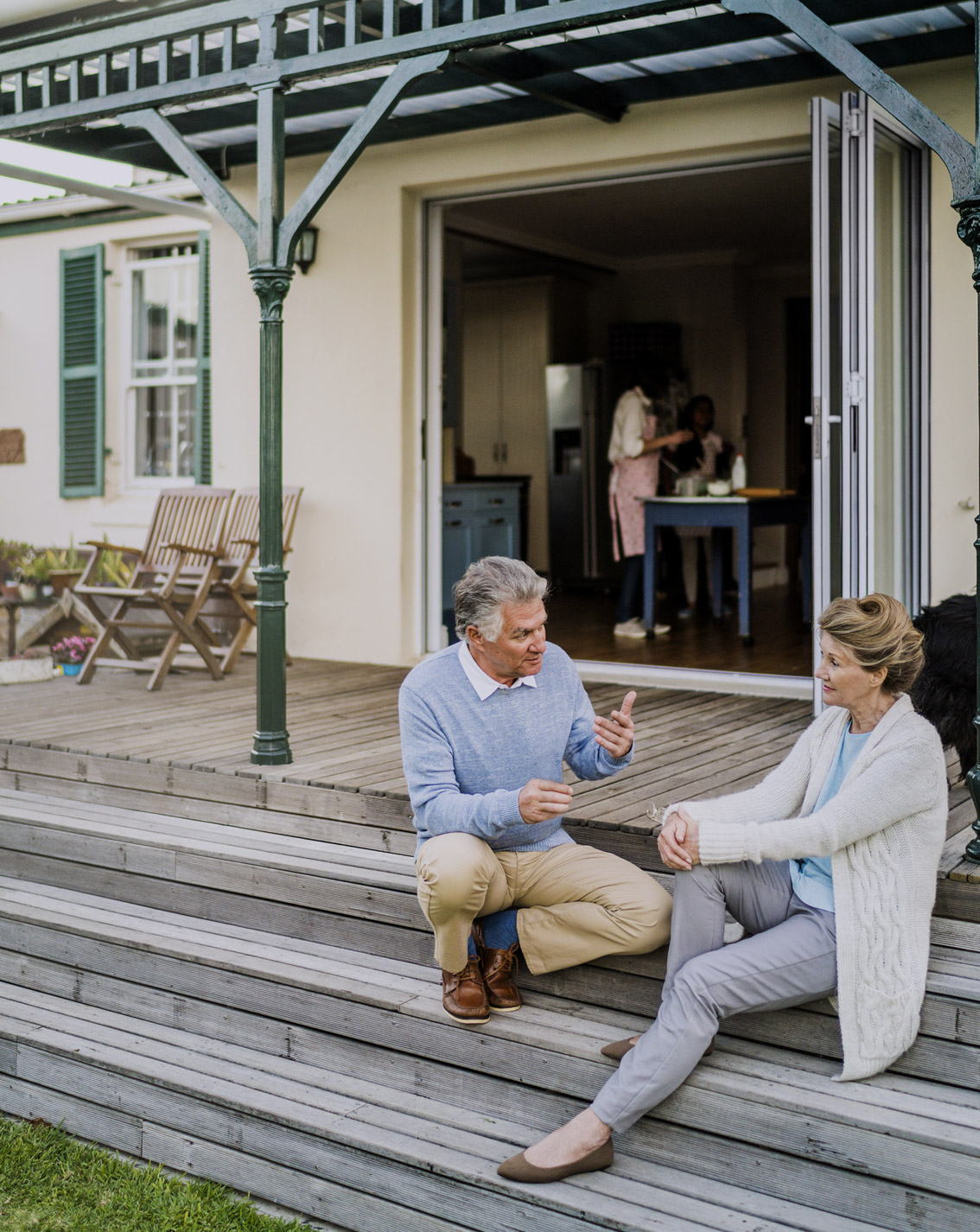 Two middle age couple having sweet talk on the front porch